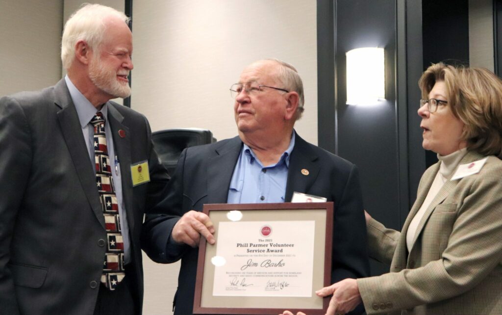 Burnet County Emergency Management Coordinator, Jim Barho (middle), accepts the Phill Parmer award from Bastrop County Judge and CAPCOG chair, Paul Pape (left), and CAPCOG Executive Director, Betty Voights.