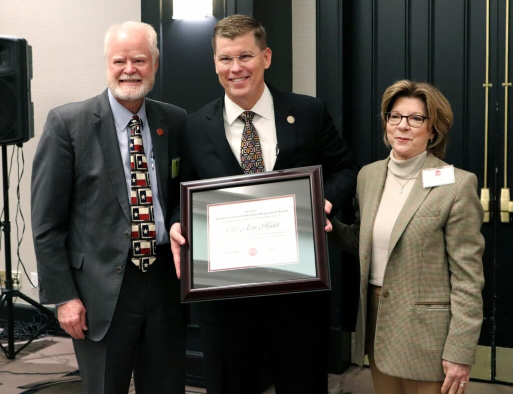 Bastrop County Judge and CAPCOG Executive Committee Chair, Paul Pape (left), and CAPCOG Executive Director, Betty Voights, present TDEM Chief, W. Nim Kidd, with the regionalism award.