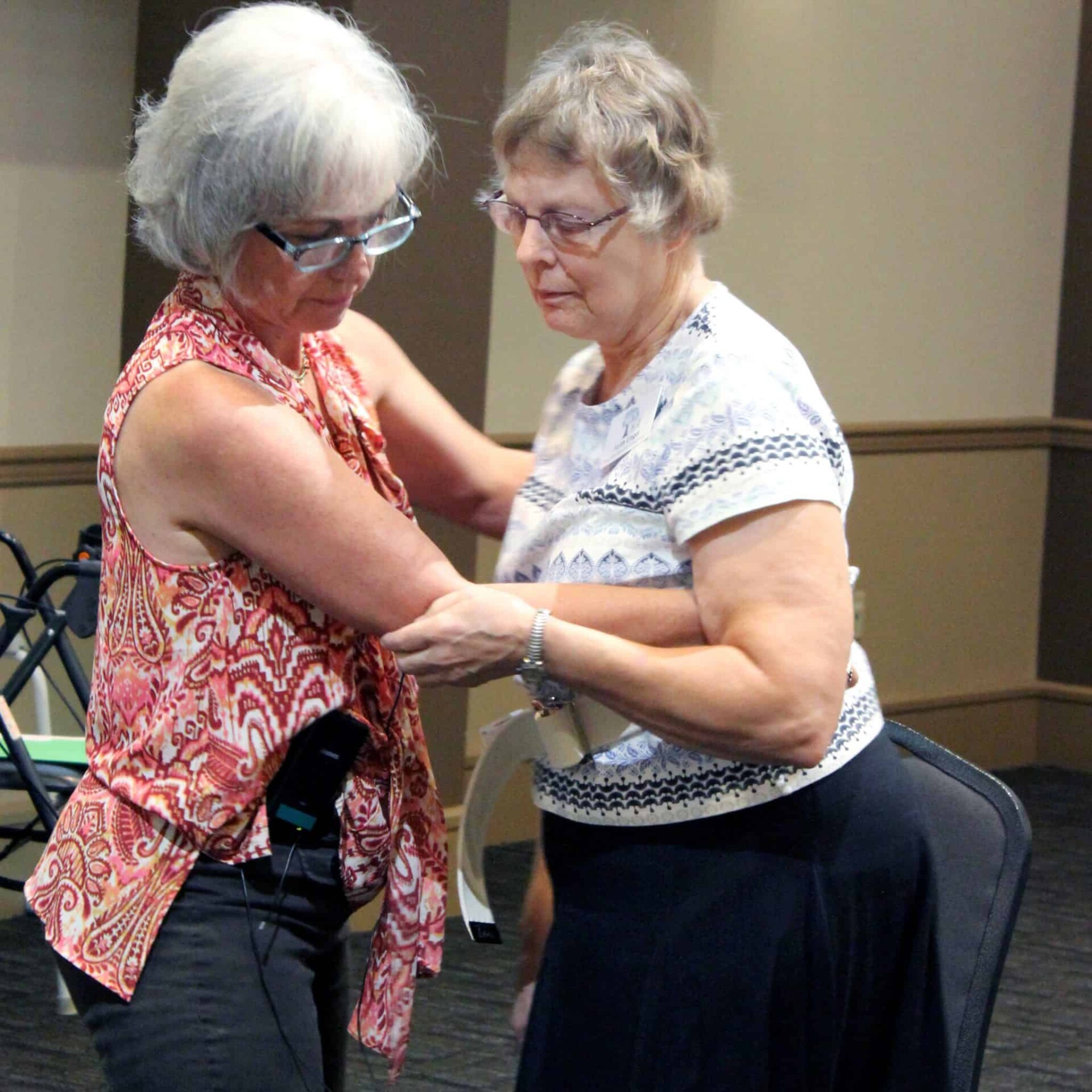 A caregiving expert demonstrates how to use a gait belt during the 2015 Striking A Balance Conference, which is put on AGE of Central Texas and the Area Agency on Aging of the Capital Area.