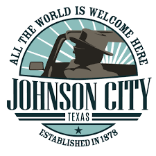 A logo that reads "All the World is Welcome Here - Johnson City Texas - Established in 1878"