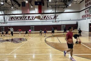 People playing basketball in the Lockhart ISD gymnasium.
